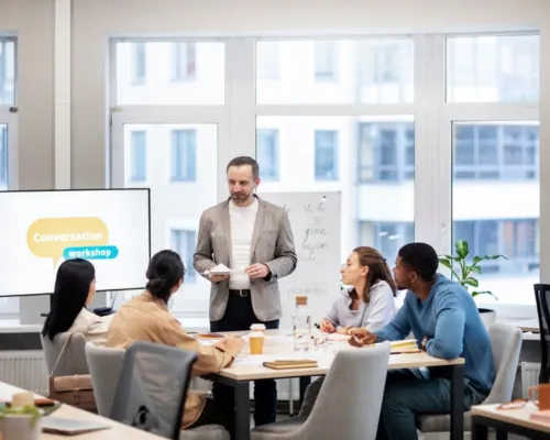 Business team attending a corporate workshop with a presenter, highlighting how organizations use digital storyboard creator tools to develop onboarding videos and internal training modules for effective communication.