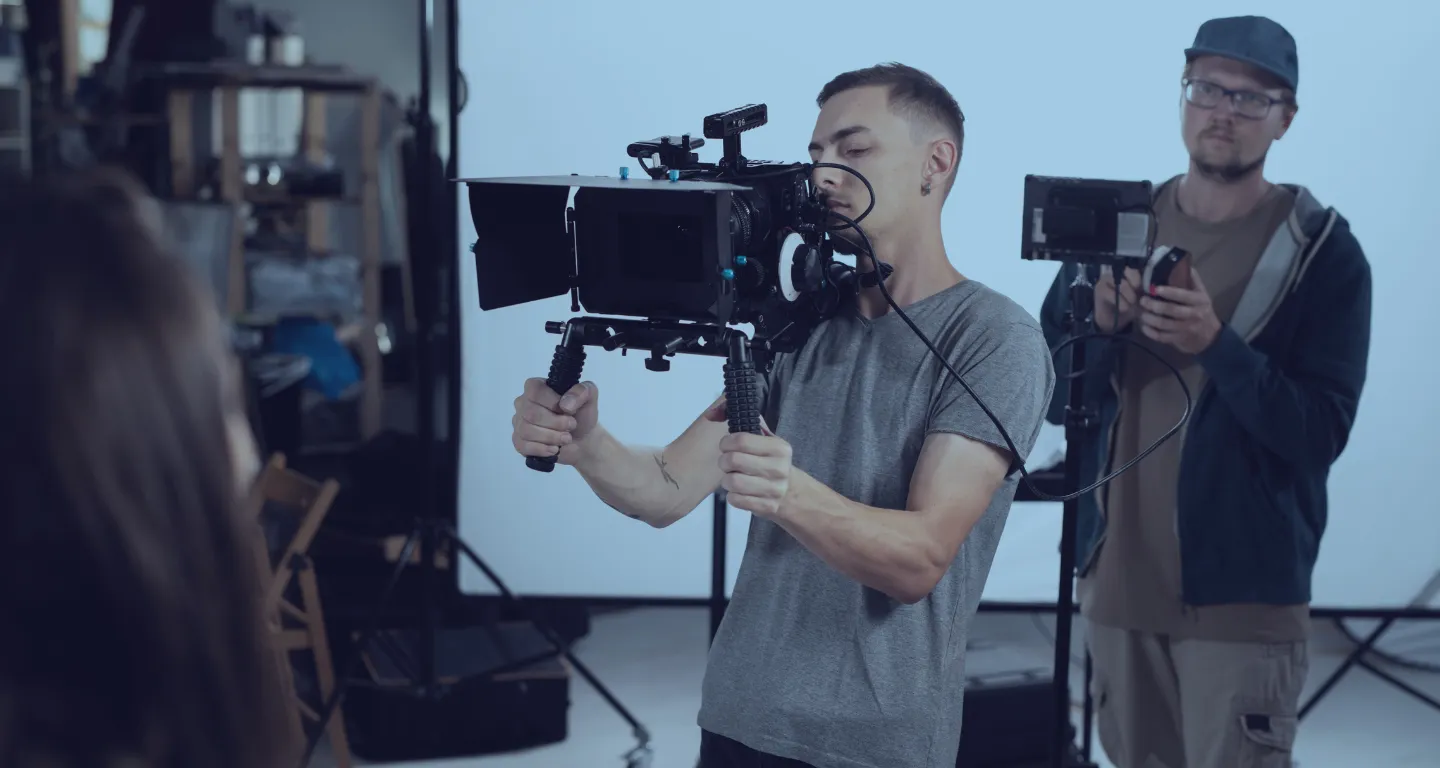 Behind-the-scenes of a video production with crew operating professional cameras—illustrating how a storyboard maker app helps schedule scenes, plan shots, and streamline the filmi